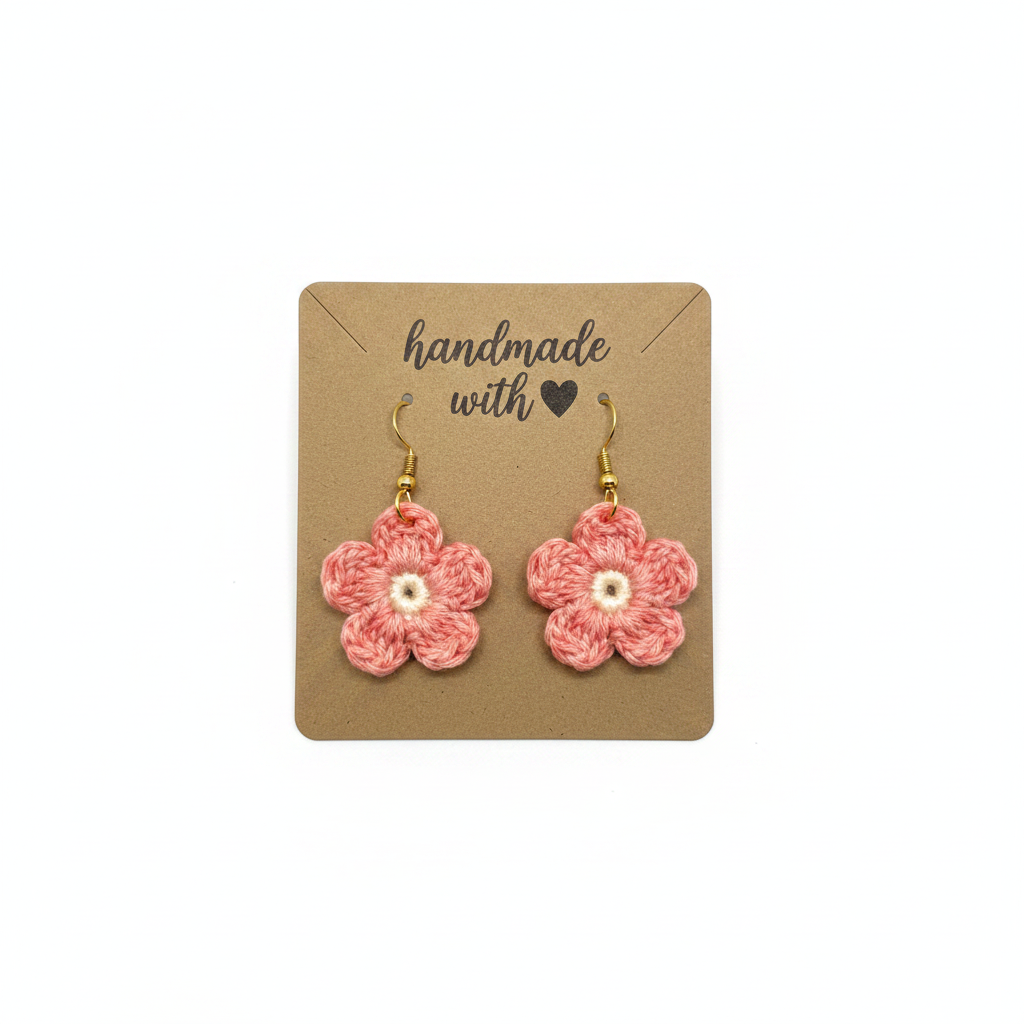 Pair of pink crocheted flower earrings on a 'handmade with love' card.